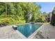 Wide backyard shot featuring a pool, playset, and lush green landscaping, perfect for outdoor enjoyment and Gathering fun at 517 Myrna Ln, Wake Forest, NC 27587