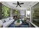 Inviting screened porch with a stone fireplace, a ceiling fan, and plenty of natural light at 517 Myrna Ln, Wake Forest, NC 27587