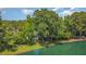 Stunning aerial view of lakefront property surrounded by lush greenery, offering peace and privacy at 5216 Sunset Fairways Dr, Holly Springs, NC 27540