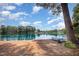 Lakeside backyard with a boat, providing easy access to water activities and scenic relaxation at 5216 Sunset Fairways Dr, Holly Springs, NC 27540
