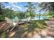 Relaxing lakeside spot with Adirondack chairs around a fire pit, perfect for enjoying serene water views at 5216 Sunset Fairways Dr, Holly Springs, NC 27540