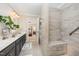 Bathroom featuring a double vanity, large shower, and open entrance to the bedroom at 5216 Sunset Fairways Dr, Holly Springs, NC 27540
