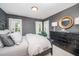 Stylish bedroom showcases a bed, dresser, white curtains, and bright windows at 5216 Sunset Fairways Dr, Holly Springs, NC 27540