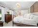 Inviting bedroom featuring a bed, dresser, closet, and sunny windows at 5216 Sunset Fairways Dr, Holly Springs, NC 27540