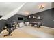 Finished bonus room showcasing a recreation area with exercise equipment and an air hockey table at 5216 Sunset Fairways Dr, Holly Springs, NC 27540