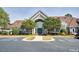 Exterior view of a clubhouse with manicured landscaping and accessible parking spaces at 5216 Sunset Fairways Dr, Holly Springs, NC 27540