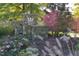 Beautiful stone community sign, Sunset Ridge at Devil's Ridge with lush landscaping and colorful flowers at 5216 Sunset Fairways Dr, Holly Springs, NC 27540