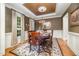 This dining room boasts hardwood floors, a wooden table, and a decorative chandelier at 5216 Sunset Fairways Dr, Holly Springs, NC 27540