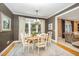 Bright dining room with a view, featuring hardwood floors and elegant decor at 5216 Sunset Fairways Dr, Holly Springs, NC 27540