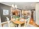 Charming dining area with stylish chandelier flows into the kitchen and living areas at 5216 Sunset Fairways Dr, Holly Springs, NC 27540