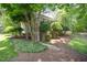 Charming home with a screened porch surrounded by mature landscaping and a well-maintained yard at 5216 Sunset Fairways Dr, Holly Springs, NC 27540