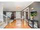Spacious foyer with hardwood floors, chandelier, and an open view to living and dining areas at 5216 Sunset Fairways Dr, Holly Springs, NC 27540