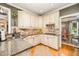Cozy kitchen features granite countertops, light wood cabinets, and modern appliances at 5216 Sunset Fairways Dr, Holly Springs, NC 27540