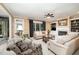Comfortable living room with a fireplace, built-in shelves, and plenty of natural light at 5216 Sunset Fairways Dr, Holly Springs, NC 27540