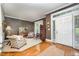 Elegant living room featuring hardwood floors, neutral decor, and a bright white entrance way at 5216 Sunset Fairways Dr, Holly Springs, NC 27540