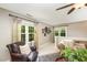 Comfortable living room features a leather chair, decorative clock, and windows with natural light at 5216 Sunset Fairways Dr, Holly Springs, NC 27540