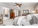 Spacious bedroom features a four-poster bed, a dresser, and an ensuite bathroom at 5216 Sunset Fairways Dr, Holly Springs, NC 27540