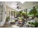 Relaxing screened porch featuring a ceiling fan, comfortable seating, and views of the outdoors at 5216 Sunset Fairways Dr, Holly Springs, NC 27540