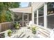 Charming screened porch with an outdoor sitting area, perfect for enjoying the peaceful surroundings at 5216 Sunset Fairways Dr, Holly Springs, NC 27540