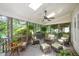 Inviting screened porch with comfortable seating and views of the lush surrounding greenery at 5216 Sunset Fairways Dr, Holly Springs, NC 27540