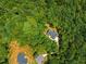 Aerial perspective of property's wooded lot and neighboring homes, offering privacy and a peaceful atmosphere at 5300 Langdon Dr, Oxford, NC 27565