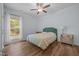 Well-lit bedroom with hardwood floors and a window overlooking the backyard at 5300 Langdon Dr, Oxford, NC 27565