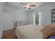 Comfortable bedroom with a window overlooking the backyard, hardwood floors, and ceiling fan at 5300 Langdon Dr, Oxford, NC 27565
