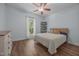 Bright bedroom with hardwood floors, large window, and decorative shelving at 5300 Langdon Dr, Oxford, NC 27565