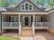 Welcoming front entrance with a covered porch and manicured landscaping leading to the front door at 5300 Langdon Dr, Oxford, NC 27565