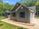 Home exterior with gray siding, black shutters, and attached two-car garage at 5300 Langdon Dr, Oxford, NC 27565