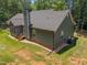 Side view of the charming home with gray siding, green lawn, and gravel landscaping at 5300 Langdon Dr, Oxford, NC 27565