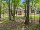 Exterior front of home partially obscured by trees, featuring a gray facade at 5300 Langdon Dr, Oxford, NC 27565