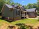 Exterior side view showcasing siding, complemented by a lush green lawn and landscaping at 5300 Langdon Dr, Oxford, NC 27565