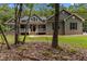 Charming exterior of home featuring neutral siding, complemented by lush trees surrounding the property at 5300 Langdon Dr, Oxford, NC 27565
