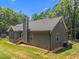 Rear exterior view showcasing architectural details and lush surroundings, exuding tranquility at 5300 Langdon Dr, Oxford, NC 27565