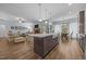 Open-concept living space with a modern kitchen, island seating, and adjacent living area at 5300 Langdon Dr, Oxford, NC 27565