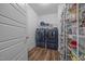 Convenient laundry room with a full-sized washer and dryer and storage shelves at 5300 Langdon Dr, Oxford, NC 27565
