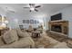 Cozy living room with a stone fireplace, comfortable seating, and natural light at 5300 Langdon Dr, Oxford, NC 27565