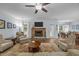 Open living room with stone fireplace, access to the backyard, and hardwood flooring at 5300 Langdon Dr, Oxford, NC 27565