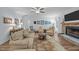 Bright living room features a stone fireplace, ceiling fan, and hardwood flooring at 5300 Langdon Dr, Oxford, NC 27565