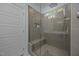 Modern bathroom shower with glass door, built-in bench, and tiled walls at 5300 Langdon Dr, Oxford, NC 27565