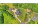 This aerial view captures the layout of the property and long drive, and sheds, and a well-maintained yard at 5328 Trackway Dr, Knightdale, NC 27545