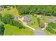 Aerial view of the property showing the home, long driveway, outbuildings and surrounding landscape at 5328 Trackway Dr, Knightdale, NC 27545