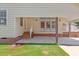 Exterior of the home featuring a concrete patio, backyard with lush green grass and mature shade trees at 5328 Trackway Dr, Knightdale, NC 27545