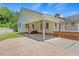 Rear exterior showcasing the covered area, patio, and lattice detailing of the home at 5328 Trackway Dr, Knightdale, NC 27545
