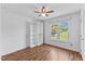 Bedroom boasts wood floors, ceiling fan, a closet system, and natural light from a window at 5328 Trackway Dr, Knightdale, NC 27545