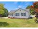 Well-maintained one-story home showcasing blue shutters, manicured landscaping, and mature shade trees at 5328 Trackway Dr, Knightdale, NC 27545