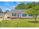 Charming single-story home featuring a well-manicured lawn, quaint front porch, and a detached garage at 5328 Trackway Dr, Knightdale, NC 27545
