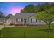 Charming single-story home featuring a well-manicured lawn, quaint front porch, and a detached garage at 5328 Trackway Dr, Knightdale, NC 27545