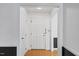 Bright hallway with white walls, dark trim, and a closed white door at 5328 Trackway Dr, Knightdale, NC 27545